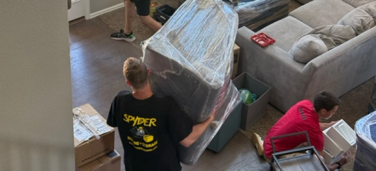 one of the movers in Memphis TN carrying a piece of furniture